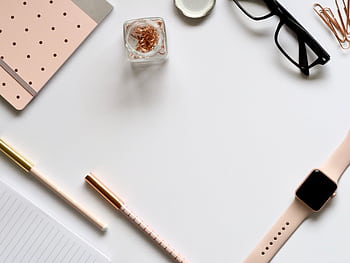 Stylish rose gold themed flatlay featuring office supplies and a smartwatch on a white background. HD wallpaper