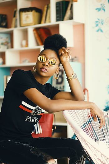 Stylish woman posing indoors wearing sunglasses and trendy attire. Modern fashion and elegance captured. HD phone wallpaper