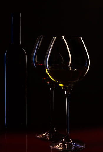Elegant silhouette of wine glasses with a bottle in moody lighting, perfect for a classy atmosphere. HD phone wallpaper