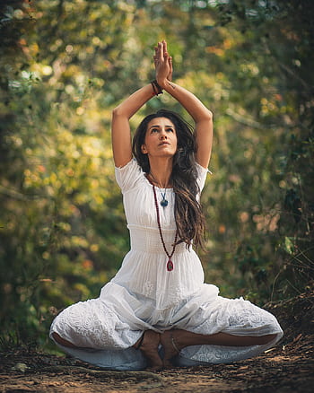 A woman meditating outdoors in a forest setting, embracing tranquility. HD phone wallpaper