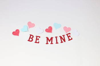 Charming arrangement of colorful hearts and 'Be Mine' text, perfect for Valentine's Day. HD wallpaper