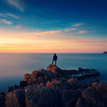 Coast, rocks, man, explorer, sunset HD phone wallpaper