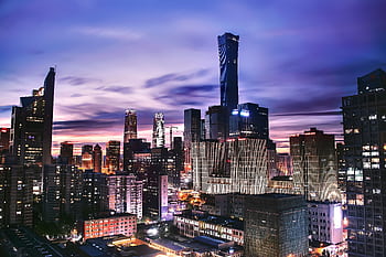 Explore the vibrant skyline of Beijing as twilight paints the horizon in this stunning aerial shot. HD wallpaper