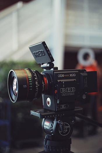 Close-up of a RED Raven video camera on a tripod, perfect for filmmaking and video production. HD phone wallpaper