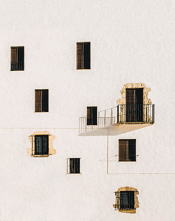 Minimalist architecture featuring a white wall with windows and shadows creating a dramatic effect. HD phone wallpaper