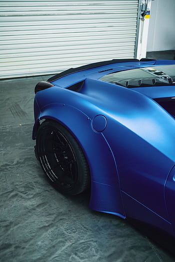 Close-up of a modern blue sports car parked in a garage. Luxurious and high-performance design. HD phone wallpaper