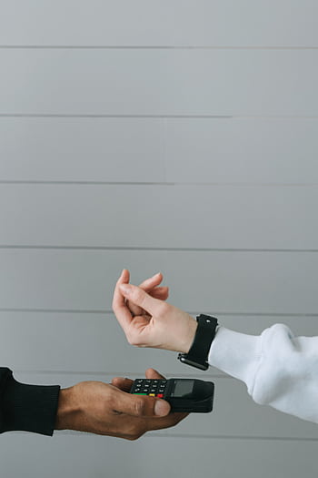 Close-up of a smartwatch being used for a contactless payment at a digital card terminal. HD phone wallpaper