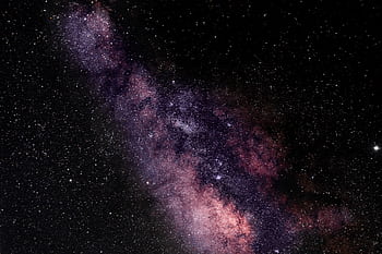 A breathtaking view of the Milky Way galaxy illuminating the night sky with vibrant colors. HD wallpaper