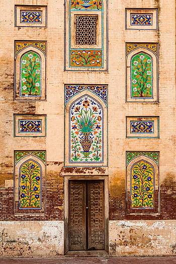 Detailed view of the intricate Mughal architectural facade in Lahore, Pakistan. HD phone wallpaper