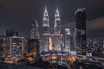 A breathtaking night view of Kuala Lumpur's skyline featuring the illuminated Petronas Towers. HD wallpaper