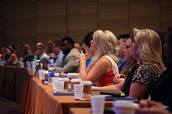 Diverse group of business professionals attentive during a conference session in a meeting room. HD wallpaper