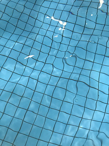 Close-up view of serene pool water with ripples and light reflections on a sunny day. HD phone wallpaper