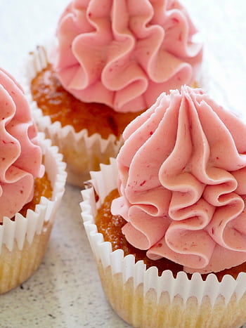Tasty cupcakes with pink frosting, perfect for a sweet treat or dessert celebration. HD phone wallpaper