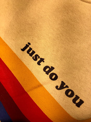 Close-up of vibrant fabric with motivational text 'just do you' on colorful stripes. HD phone wallpaper