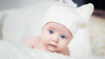 Blue Eyes Cute Toddler Baby Is Lying Down On Fur Cloth Wearing White Woolen Knitted Cap Cute HD wallpaper