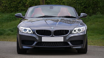 Front view of a luxurious BMW Z4 convertible car on a que road, showcasing sleek design. HD wallpaper