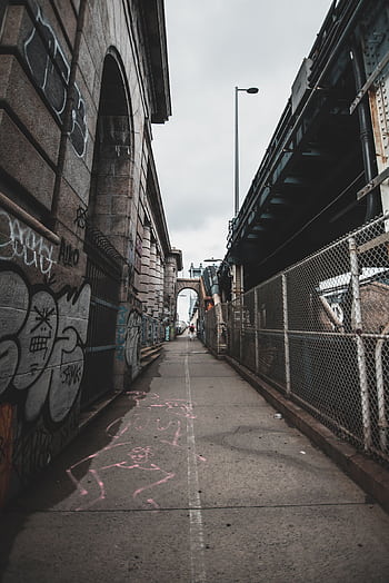 A gritty city alley in New York City with graffiti and architectural details. HD phone wallpaper