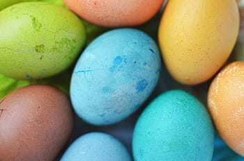 Vibrant close-up of colorful Easter eggs in various shades, perfect for seasonal themes. HD wallpaper
