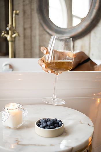 Indulge in a luxurious bath with wine, candlelight, and fresh blueberries for a serene, spa-like experience. HD phone wallpaper