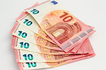 Close-up of a fan of 10 euro banknotes on a clean white background, showcasing European currency. HD wallpaper