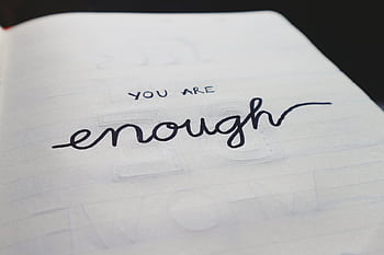 A close-up of a notebook page with motivational handwritten text: 