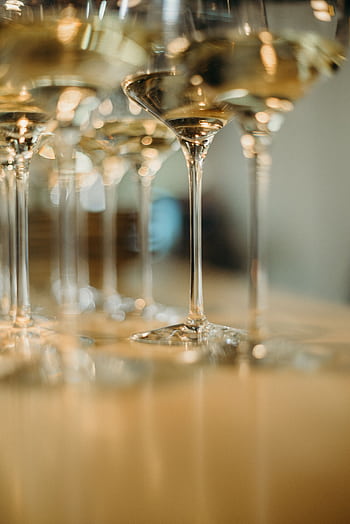 A close-up of elegantly arranged white wine glasses creating a sophisticated atmosphere. HD phone wallpaper