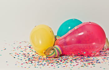 Vibrant colorful balloons surrounded by confetti, perfect for party celebrations. HD wallpaper