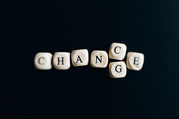 Letter dice forming the word 'Change' on a dark background, symbolizing transformation and opportunity. HD wallpaper