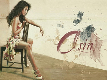 Asin Thottumkal, beige wall, sitting on chair, dark hair, white strappped heels, paattern with name, illustration, floral dress HD wallpaper
