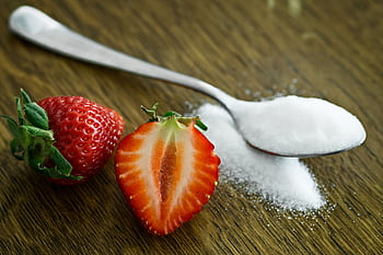 Close-up of fresh strawberries with sugar on a wooden table. Perfect for healthy dessert ideas. HD wallpaper