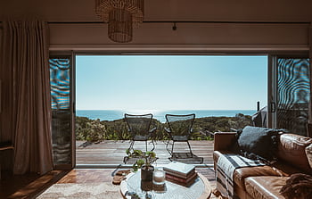 Experience tranquility in a modern interior with ocean view, perfect for relaxation and comfort. HD wallpaper