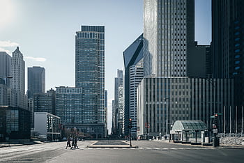 Urban cityscape of Chicago with towering skyscrapers and a calm street view. HD wallpaper