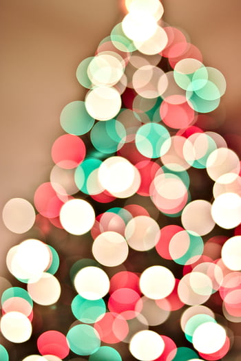 Festive abstract bokeh of Christmas lights creating a blurred colorful pattern. HD phone wallpaper
