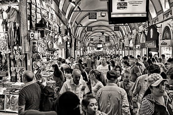A crowded scene capturing the vibrant commerce of Istanbul's famous Grand Bazaar, showcasing the lively atmosphere and diverse society. HD wallpaper