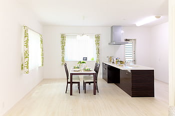 Sleek modern kitchen and dining area with natural light and minimalistic decor. HD wallpaper