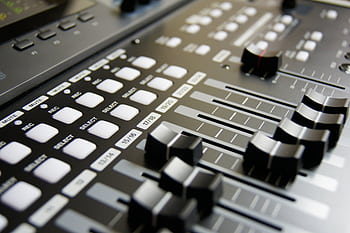 Detailed view of audio mixer sliders and buttons for sound engineering and music production. HD wallpaper