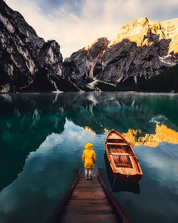 A peaceful lake surrounded by mountains with a dock and boat, perfect for adventure and reflection. HD phone wallpaper