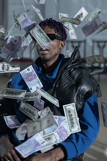 A stylish man with a leather jacket and sunglasses surrounded by floating currency notes. HD phone wallpaper