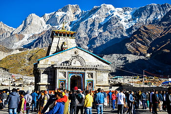 Crowd gathers at Kedarnath Temple with Himalayas backdrop, showcasing religious significance and stunning landscape. HD wallpaper
