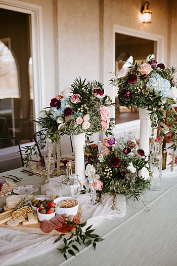 Beautiful floral arrangement on a wedding table with vintage decor and snacks in a romantic setting. HD phone wallpaper