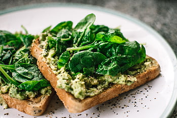 Close-up of a homemade avocado and spinach sandwich on whole grain toast. HD wallpaper