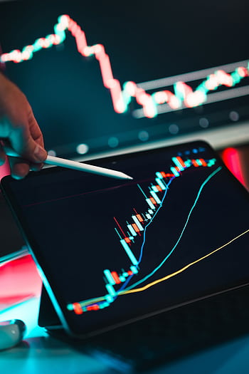 Close-up of cryptocurrency trading analysis on a digital tablet, highlighting market trends. HD phone wallpaper