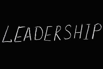 Chalk text spelling 'Leadership' on a blackboard, symbolizing guidance and authority. HD wallpaper