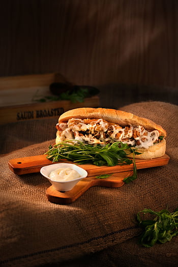 Delicious chicken sandwich with mayonnaise and greens served on a wooden board. HD phone wallpaper