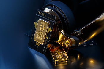 Elegant of gold bars paired with sleek gold heads, symbolizing wealth and luxury. HD wallpaper