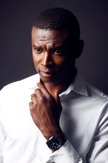 Portrait of a thoughtful man in a crisp white shirt with a serious expression. HD phone wallpaper