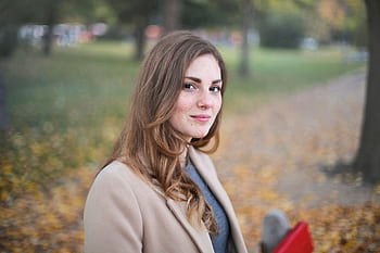 A woman smiles in an autumn setting in Budapest, Hungary. HD wallpaper