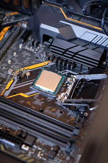 Detailed view of a motherboard with an exposed CPU, showcasing technology components. HD phone wallpaper