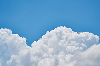 Vibrant of fluffy white clouds against a clear blue sky, perfect for nature and weather themes. HD wallpaper