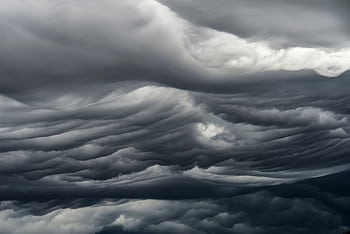 Majestic dark clouds showcasing dramatic weather patterns with strong atmospheric mood. HD wallpaper